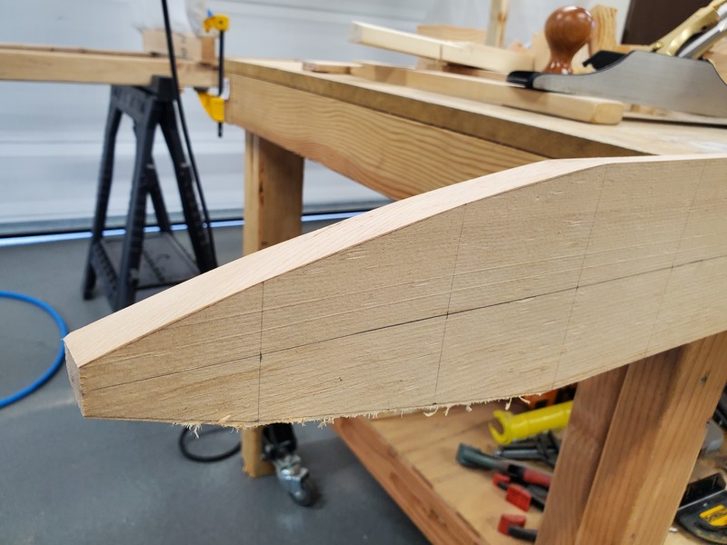The tapered end of a wing spar, cut cleanly on the top surface,
with the bottom surface still rough-cut